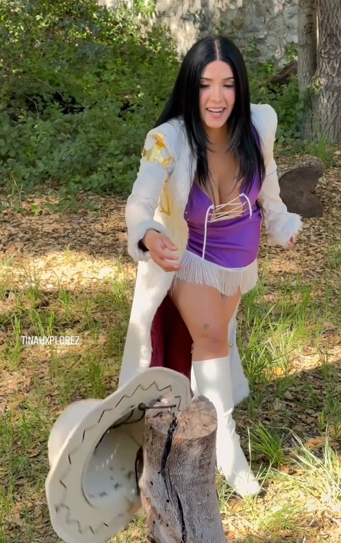 Tina the Xplorer in a white coat and purple character outfit outdoors